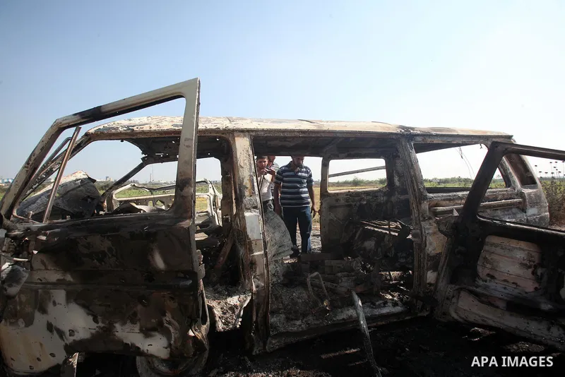 Palestinians inspect a destroyed vehicle following an Israeli bombing in Gaza City on July 12, 2012. A Palestinian was killed and others wounded after an Israeli air strike in al-Zeitoun area in the east of Gaza city on...