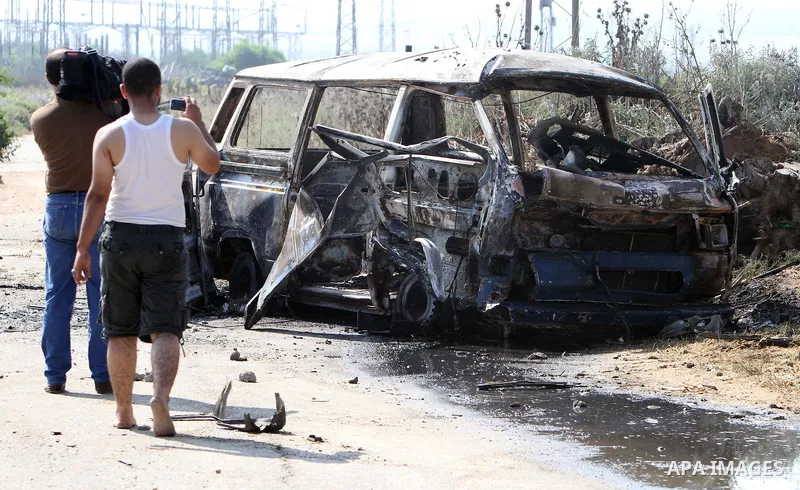 Palestinians inspect a destroyed vehicle following an Israeli bombing in Gaza City on July 12, 2012. A Palestinian was killed and others wounded after an Israeli air strike in al-Zeitoun area in the east of Gaza city on...