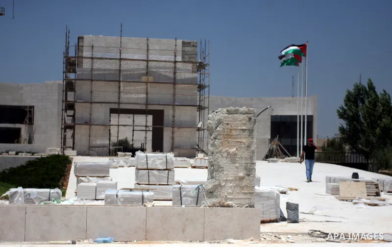 Workers walk outside the memorial building for the late Palestinian leader Yasser Arafat in the West Bank city of Ramallah on July, 12, 2012. Palestinian Justice Minister Ali Mohanna said Thursday investigators looking i...