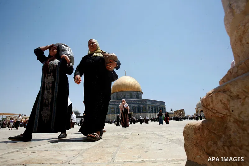 Palestinian Muslim worshippers walk in front of the Dome of Rock mosque during Friday prayers, in the Al Aqsa Mosque compound, in Jerusalem's old city on July 13, 2012. Photo by Mahfouz Abu Turk