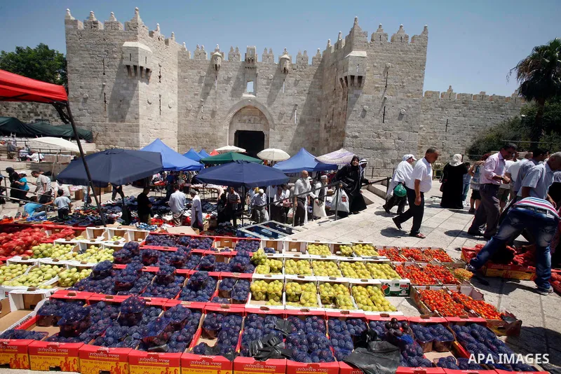 A Palestinian vendor displays his goods following Friday prayers, in the old city of Jerusalem on July 13, 2012. Photo by Mahfouz Abu Turk