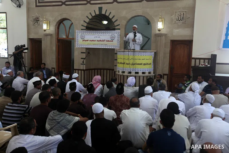 Palestinians listen to Palestinian Prime Minister in Gaza Ismail Haniyeh speech during Friday prayer in Gaza City on 13 July 2012.. Photo by Majdi Fathi