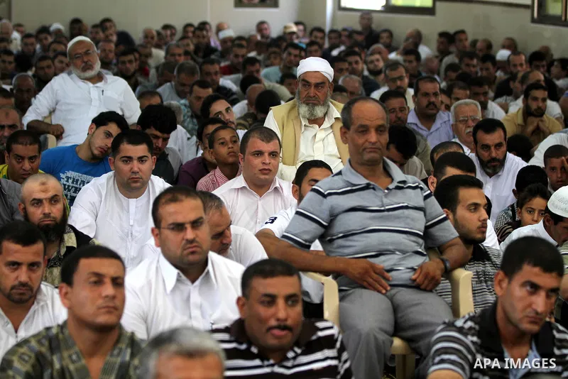 Palestinians listen to Palestinian Prime Minister in Gaza Ismail Haniyeh speech during Friday prayer in Gaza City on 13 July 2012.. Photo by Majdi Fathi