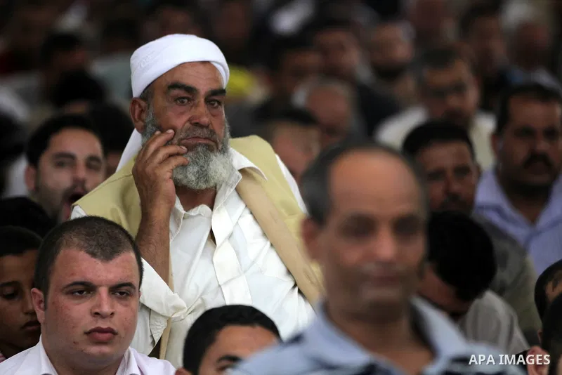 Palestinians listen to Palestinian Prime Minister in Gaza Ismail Haniyeh speech during Friday prayer in Gaza City on 13 July 2012.. Photo by Majdi Fathi