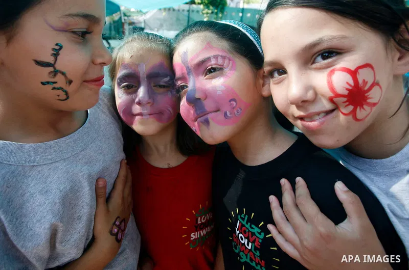Palestinian children paint national flags on their faces during a rally on 13 July, 2012 in the east Jerusalem neighborhood of Silwan against Jewish settlement and the judaization in Palestinian districts of the holy cit...