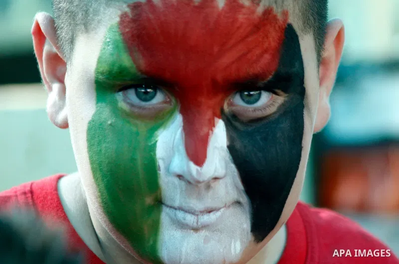 A Palestinian child paints a national flag on his face during a rally on 13 July, 2012 in the east Jerusalem neighborhood of Silwan against Jewish settlement and the judaization in Palestinian districts of the holy city....