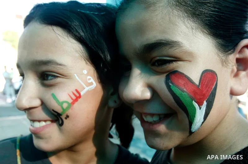 Palestinian children paint national flags on their faces during a rally on 13 July, 2012 in the east Jerusalem neighborhood of Silwan against Jewish settlement and the judaization in Palestinian districts of the holy cit...