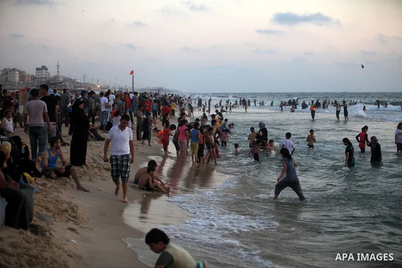 Palestinians enjoy swimming in the sea at Gaza beach on 13 July 2012 in Gaza City. Photo by Majdi Fathi