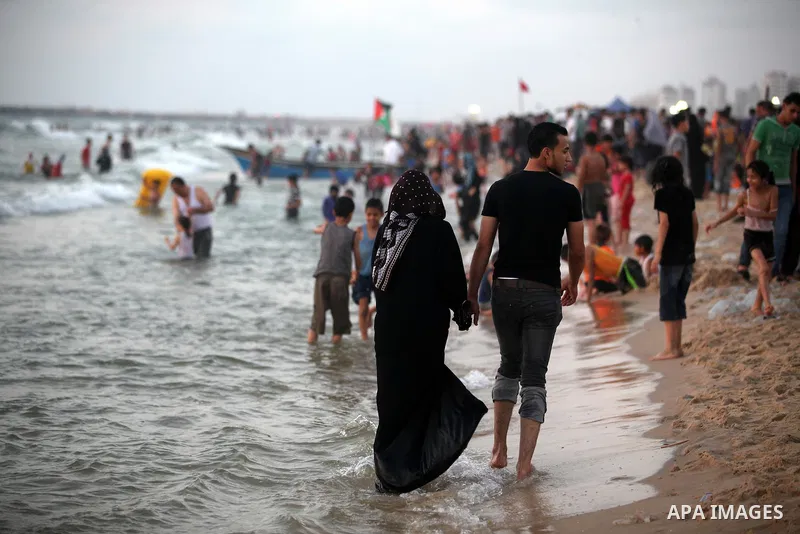 Palestinians enjoy swimming in the sea at Gaza beach on 13 July 2012 in Gaza City. Photo by Majdi Fathi