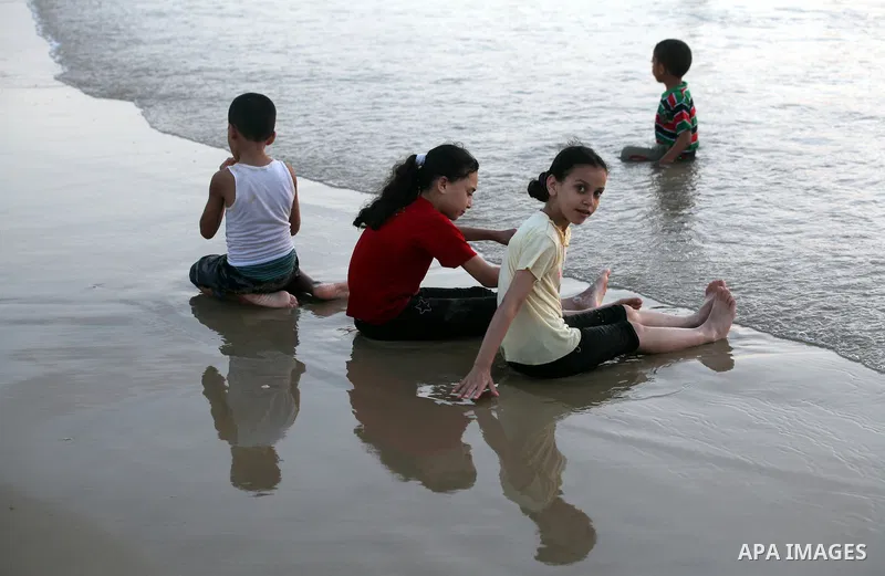 Palestinian children enjoy swimming in the sea at Gaza beach on 13 July 2012 in Gaza City. Photo by Majdi Fathi