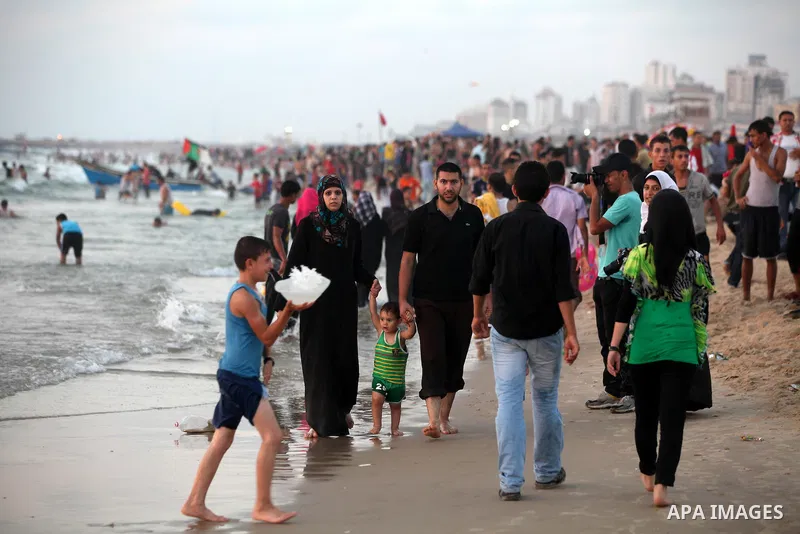 Palestinians promenade at Gaza beach on 13 July 2012 in Gaza City. Photo by Majdi Fathi