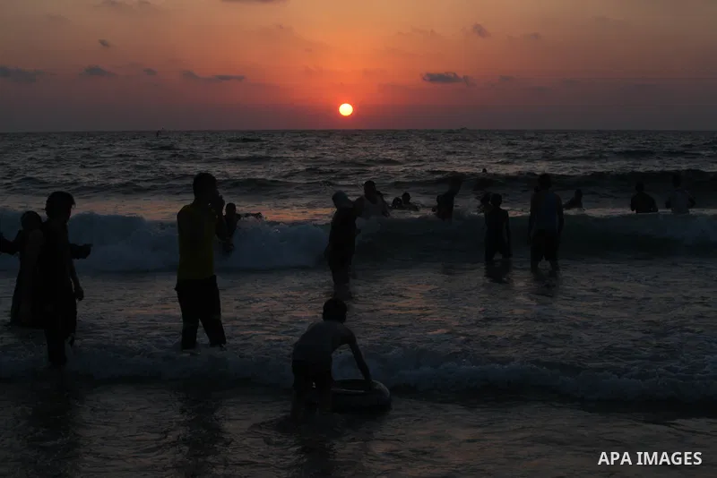 Palestinians enjoy swimming in the sea at Gaza beach on 13 July 2012 in Gaza City. Photo by Majdi Fathi