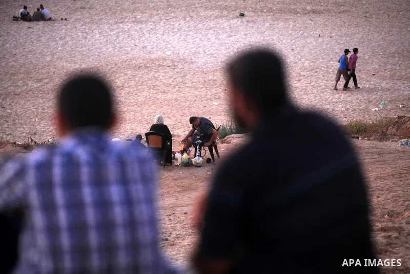 Palestinians promenade at Gaza beach on 13 July 2012 in Gaza City. Photo by Majdi Fathi