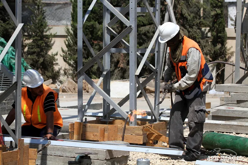 Palestinians workers work in energy company during maintenance work in Gaza city, on July 14, 2012. Photo by Majdi Fathi