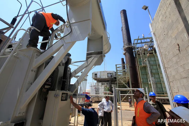 Palestinians workers work in energy company during maintenance work in Gaza city, on July 14, 2012. Photo by Majdi Fathi