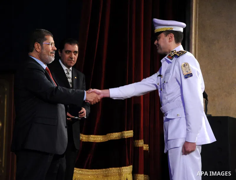 In this image released by the Egyptian Presidency, Egyptian President, Mohammed Morsi at a graduation ceremony at the Police Academy headquarters in Cairo, Egypt, July 14, 2012. The Police Academy was also the venue for...