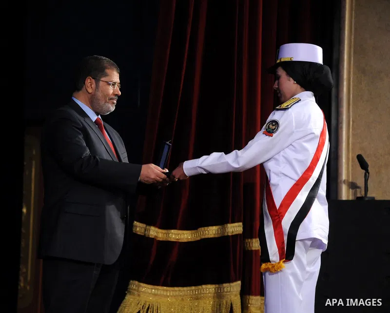 In this image released by the Egyptian Presidency, Egyptian President, Mohammed Morsi at a graduation ceremony at the Police Academy headquarters in Cairo, Egypt, July 14, 2012. The Police Academy was also the venue for...