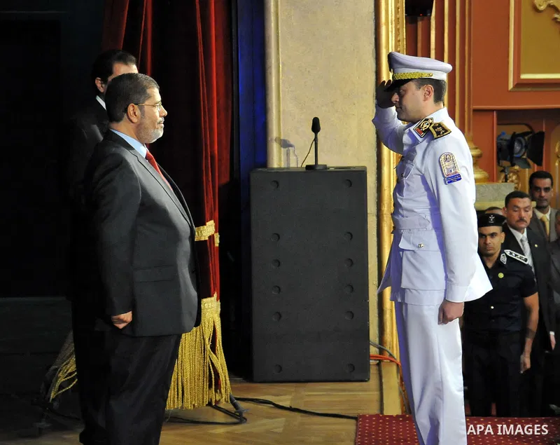 In this image released by the Egyptian Presidency, Egyptian President, Mohammed Morsi at a graduation ceremony at the Police Academy headquarters in Cairo, Egypt, July 14, 2012. The Police Academy was also the venue for...