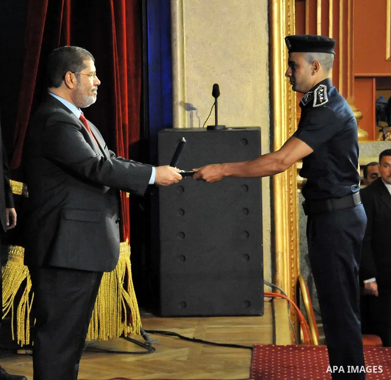 In this image released by the Egyptian Presidency, Egyptian President, Mohammed Morsi at a graduation ceremony at the Police Academy headquarters in Cairo, Egypt, July 14, 2012. The Police Academy was also the venue for...