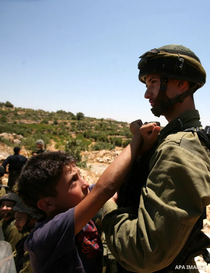 Palestinian and international demonstrators protest in the West Bank village of Susya, south Hebron, against pending demolition orders given by the Israeli Army, to demolish the village entrance, 14 July 2012. Photo by M...