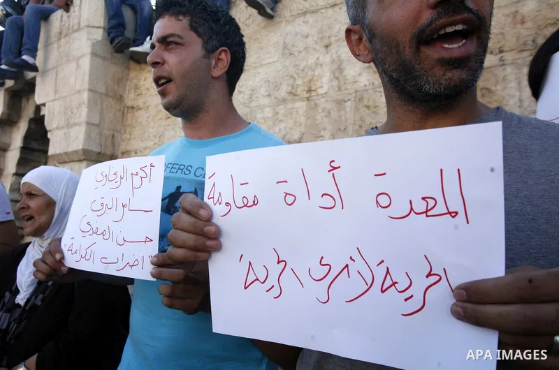 Palestinians take part a protest to calling of release of palestinian prisoners in Israeli jails whose are still refusing food for after a deal was made to end a mass prisoner hunger strike, during a demonstration in the...