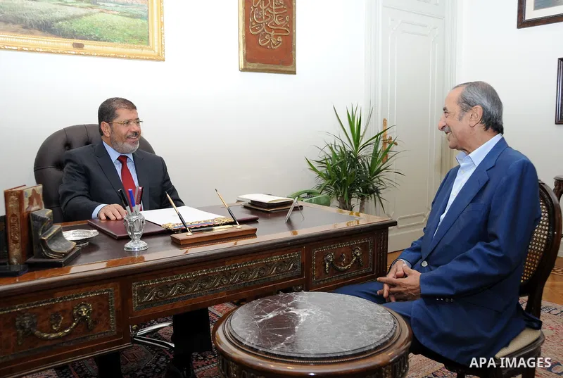 Egypt's president Mohamed Morsi, meets with journalist and Egyptian T.V presenter Hamdi Qandeel at the presidential palace in Cairo, July 14, 2012. Photo by apaimages/Egyptian Presidency/Mohamed Abd el Moaty