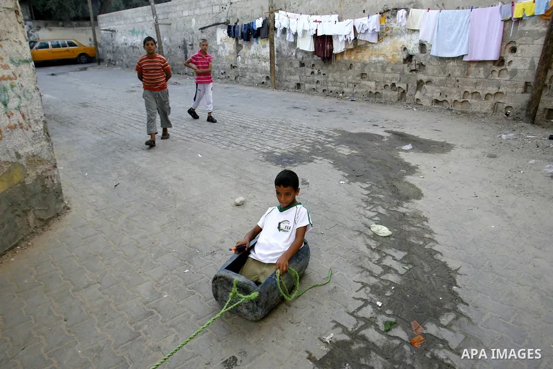 Palestinian children play outside their home in the Rafah refugee camp in the southern Gaza Strip on July 14, 2012. Photo by Eyad Al Baba