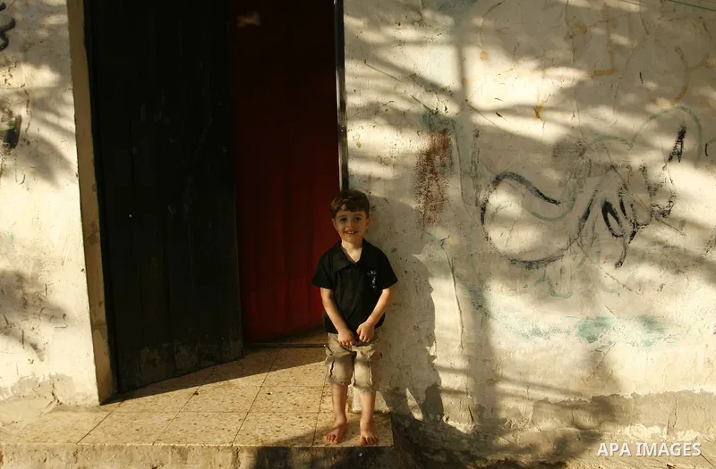 Palestinian children play outside their home in the Rafah refugee camp in the southern Gaza Strip on July 14, 2012. Photo by Eyad Al Baba
