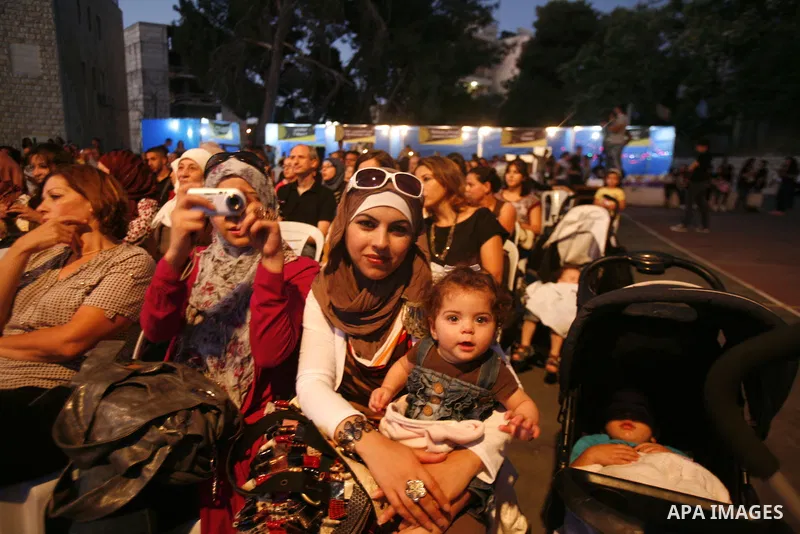 Palestinian singer Reem Talhami (not seen) during a concert at the Jerusalem Festival for singing and music, in the West Bank, city of Jerusalem , on July 14, 2012. Photo by Mahfouz Abu Turk