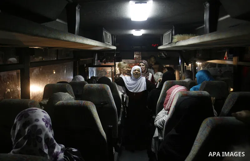 Family members of Palestinian prisoners on their way to visit their relatives jailed in Israel sit in a bus before it leaves Gaza City July 16, 2012. Israel on Monday allowed Palestinian families from the Gaza Strip to v...