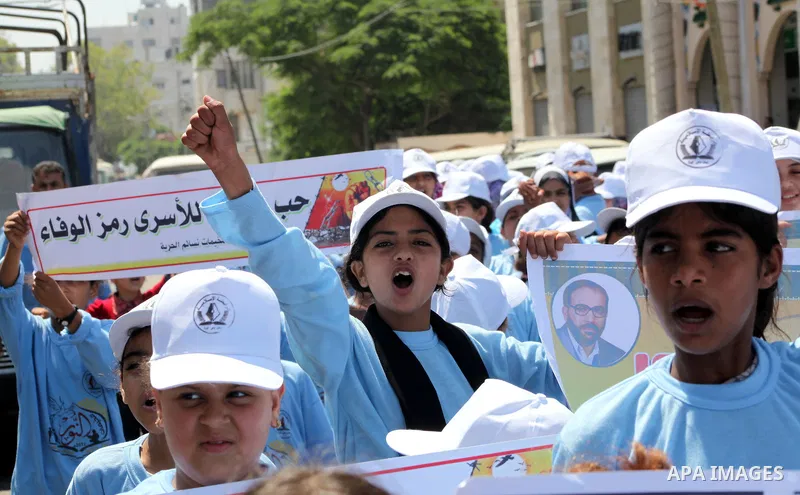Palestinian children demonstrate during a protest calling for the release of prisoners held in Israeli jails in front of the headquarters Red Cross in Gaza City, on July.16, 2012. Photo by Ashraf Amra