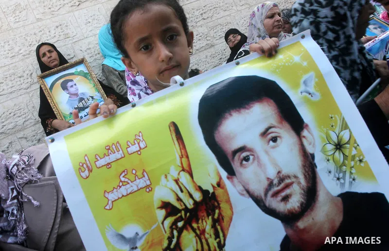 Palestinian relatives prisoners attend a protest calling for the release of their sons held in Israeli jails in front of the headquarters Red Cross in Gaza City, Gaza Strip, on July.16, 2012. Photo by Ashraf Amra