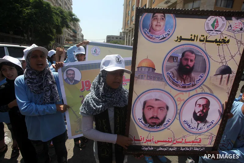 Palestinian relatives prisoners attend a protest calling for the release of their sons held in Israeli jails in front of the headquarters Red Cross in Gaza City, Gaza Strip, on July.16, 2012. Photo by Ashraf Amra