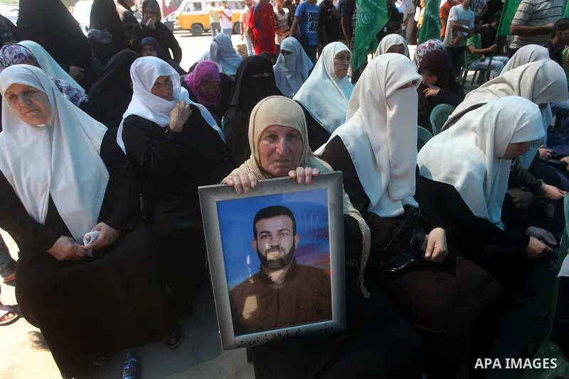 Palestinian relatives prisoners attend a protest calling for the release of their sons held in Israeli jails in front of the headquarters Red Cross in Gaza City, Gaza Strip, on July.16, 2012. Photo by Ashraf Amra