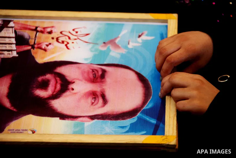 A Palestinian woman holds picture of her son during a protest calling for the release of prisoners held in Israeli jails in front of the headquarters Red Cross in Gaza City, on July.16, 2012. Photo by Ashraf Amra