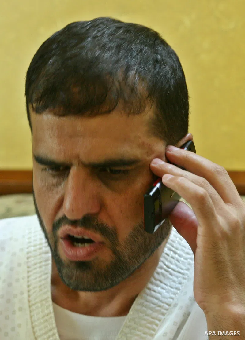 Palestinian former prisoner Adnan Asfour belonging to Hamas movement, calls a phone at his home in the West Bank city of Nablus, after being release of prisoners held in Israeli jails, on July 16, 2012. Photo by Nedal Es...