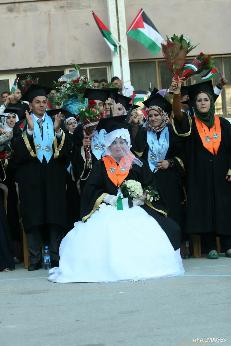 Palestinian bride celebrates her marriage during graduation ceremony at Al-Quds Open University in the West Bank city of Nablus, on July 16, 2012. Photo by Nedal Eshtayah