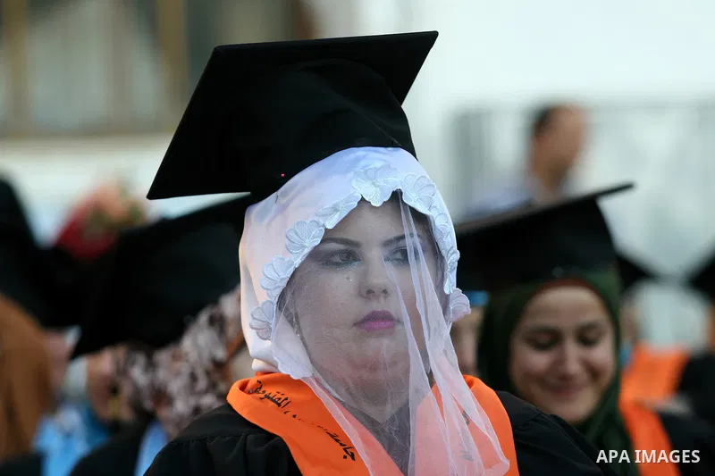 Palestinian bride celebrates her marriage during graduation ceremony at Al-Quds Open University in the West Bank city of Nablus, on July 16, 2012. Photo by Nedal Eshtayah