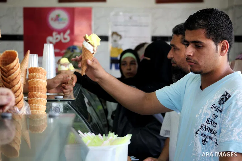 Palestinians buy ice-cream during hot weather in Gaza city, July 16, 2012. The temperature of the Gaza strip reaches more than 33 degrees Celsius and 61% humidity, Gazans escape to the beach and out from their homes duri...