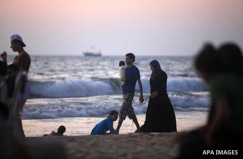 Palestinians enjoy a day at Gaza beach during hot weather in Gaza city, July 16, 2012. The temperature of the Gaza strip reaches more than 33 degrees Celsius and 61% humidity, Gazans escape to the beach and out from thei...