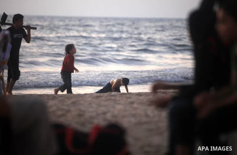 Palestinians enjoy a day at Gaza beach during hot weather in Gaza city, July 16, 2012. The temperature of the Gaza strip reaches more than 33 degrees Celsius and 61% humidity, Gazans escape to the beach and out from thei...