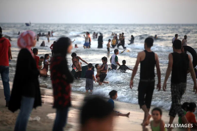 Palestinians enjoy swimming in the sea at Gaza beach during hot weather in Gaza city, July 16, 2012. The temperature of the Gaza strip reaches more than 33 degrees Celsius and 61% humidity, Gazans escape to the beach and...