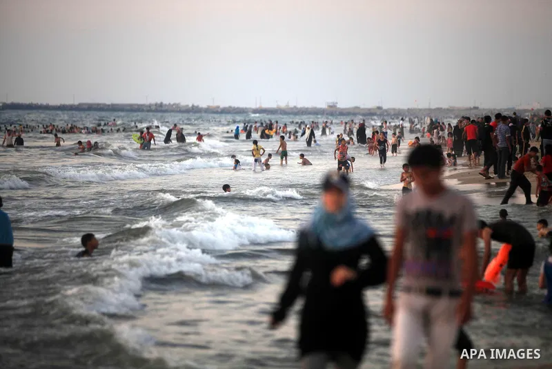 Palestinians enjoy swimming in the sea at Gaza beach during hot weather in Gaza city, July 16, 2012. The temperature of the Gaza strip reaches more than 33 degrees Celsius and 61% humidity, Gazans escape to the beach and...