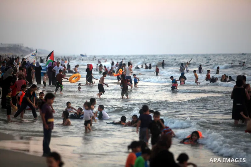 Palestinians enjoy swimming in the sea at Gaza beach during hot weather in Gaza city, July 16, 2012. The temperature of the Gaza strip reaches more than 33 degrees Celsius and 61% humidity, Gazans escape to the beach and...