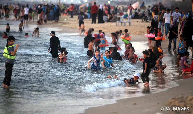 Palestinians enjoy swimming in the sea at Gaza beach during hot weather in Gaza city, July 16, 2012. The temperature of the Gaza strip reaches more than 33 degrees Celsius and 61% humidity, Gazans escape to the beach and...