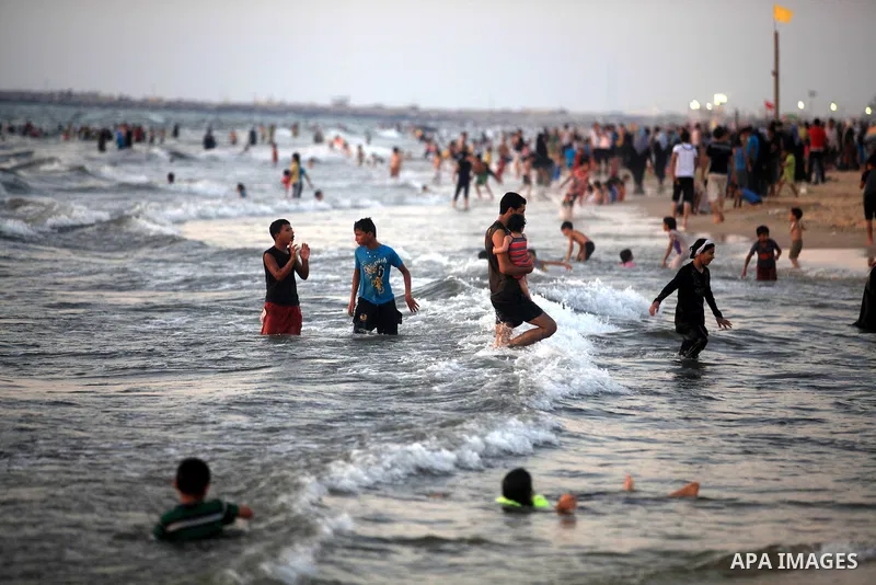Palestinians enjoy swimming in the sea at Gaza beach during hot weather in Gaza city, July 16, 2012. The temperature of the Gaza strip reaches more than 33 degrees Celsius and 61% humidity, Gazans escape to the beach and...