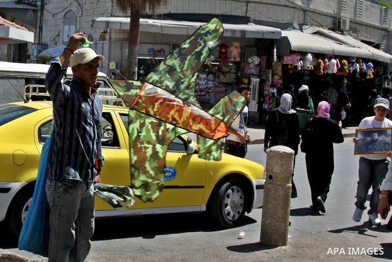 A Palestinian vendor sells kites in the street in the West Bank city of Nablus, on July 17, 2012. Photo by Nedal Eshtayah