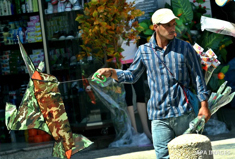 A Palestinian vendor sells kites in the street in the West Bank city of Nablus, on July 17, 2012. Photo by Nedal Eshtayah