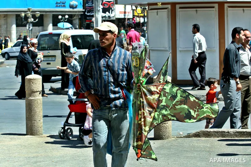A Palestinian vendor sells kites in the street in the West Bank city of Nablus, on July 17, 2012. Photo by Nedal Eshtayah