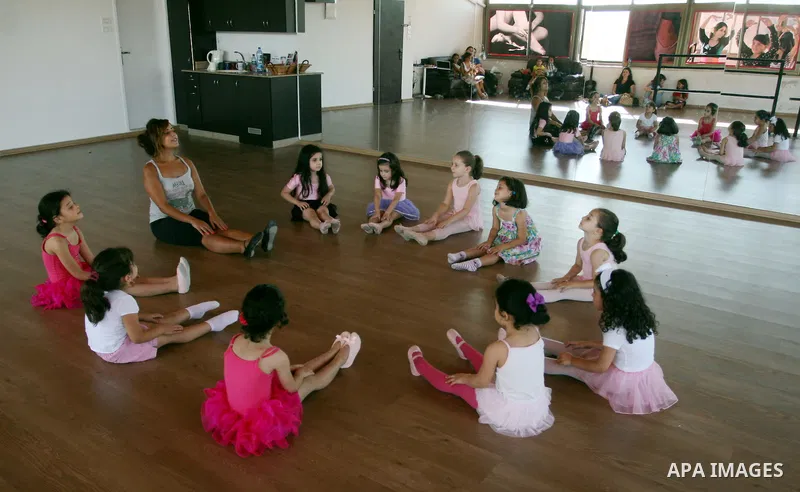 Palestinian ballet trainer, Shyrine Ziadeh , teaches young girls during summer classes at her Ramallah Ballet Center dance school, in the West bank town of Ramallah, 17 July 2012. The center teaches ballet techniques and...